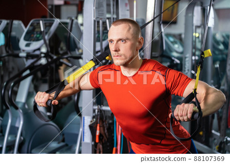 Handsome man working out in fitness gym 88107369