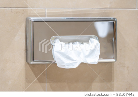 Paper towel dispenser on the wall in the bathroom Paper towel dispenser on the wall in the bathroom 88107442
