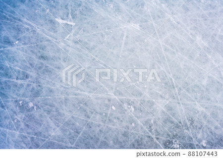 Ice background with marks from skating and hockey, blue texture of rink surface with scratches Ice background with marks from skating and hockey, blue texture of rink surface with scratches 88107443