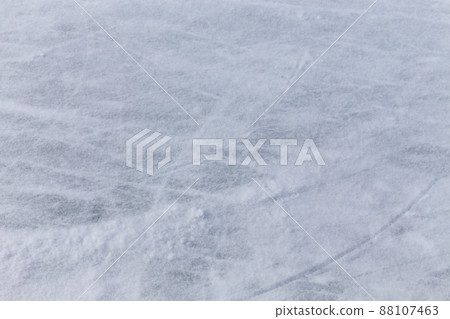 Ice background with marks from skating and hockey, blue texture of rink surface with many scratches Ice background with marks from skating and hockey, blue texture of rink surface with many scratches 88107463