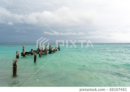 Remains of an old pier on Playa Caracol beach in Cancun, Mexico 88107481
