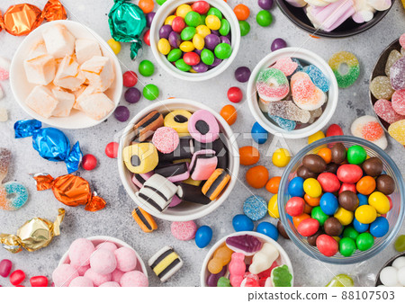 Milk chocolate candies woth shell in jar with various jelly gums candies Milk chocolate candies woth shell in jar with various jelly gums candies 88107503