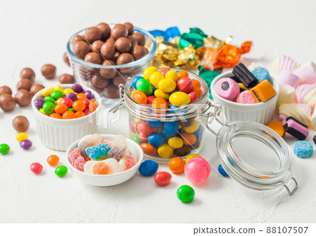 Milk chocolate candies in shell with jelly sugar gums and liquorice allsorts and fruit sherbet  88107507