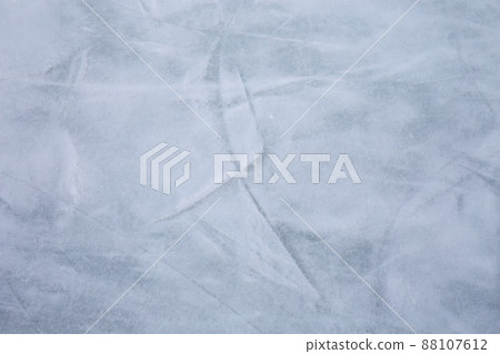 Ice background with marks from skating and hockey, blue texture of rink surface with many scratches Ice background with marks from skating and hockey, blue texture of rink surface with many scratches 88107612