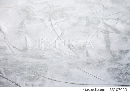 Ice background with marks from skating and hockey, blue texture of rink surface with many scratches Ice background with marks from skating and hockey, blue texture of rink surface with many scratches 88107633