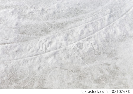 Ice background with marks from skating and hockey, blue texture of rink surface with many scratches Ice background with marks from skating and hockey, blue texture of rink surface with many scratches 88107678
