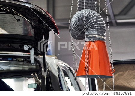 Hood of an industrial air extractor in auto repair shop Hood of an industrial air extractor in auto repair shop 88107681