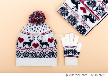 Gloves and worm woolen hat. winter set on orange background Gloves and worm woolen hat. winter set on orange background 88107695
