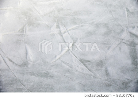 Ice background with marks from skating and hockey, blue texture of rink surface with many scratches Ice background with marks from skating and hockey, blue texture of rink surface with many scratches 88107702