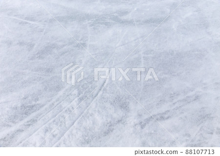 Ice background with marks from skating and hockey, blue texture of rink surface with many scratches Ice background with marks from skating and hockey, blue texture of rink surface with many scratches 88107713