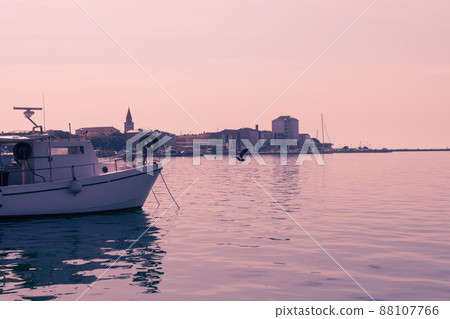 A photograph of a ship and a luxury yacht anchored in port. Beautiful photo of a Mediterranean port A photograph of a ship and a luxury yacht anchored in port. Beautiful photo of a Mediterranean port 88107766