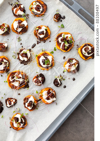 Sweet orange yam wedges with yogurt and dates Sweet orange yam wedges with yogurt and dates 88108497