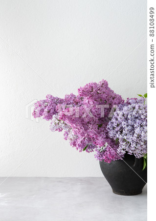 Bouquet of lilacs in a clay pot on a table Bouquet of lilacs in a clay pot on a table 88108499