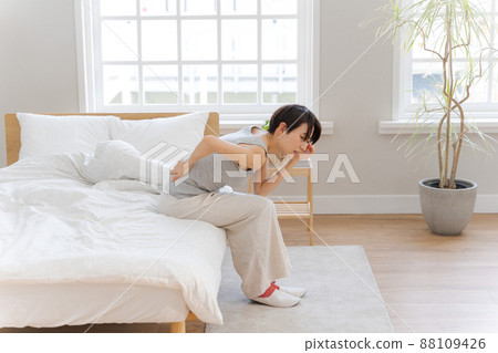 Woman with back pain Bedroom 88109426