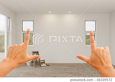 Female Hands Framing Blank Unfinisehd Walls in Empty Room of House. 88109572