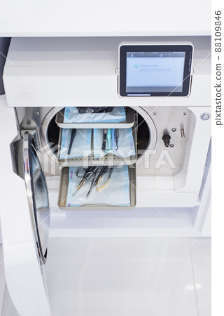 Modern laboratory autoclave with packaged dental instruments in dentistry clinic. Modern medical equipment for disinfection and sterilization. Modern laboratory autoclave with packaged dental instruments in dentistry clinic. Modern medical equipment for disinfection and sterilization. 88109846