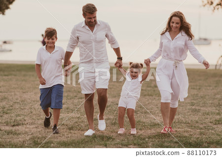 Senior couple in casual clothes with their children, boy and girl enjoy the beach spending a vacation together. Family time . Selective focus  88110173