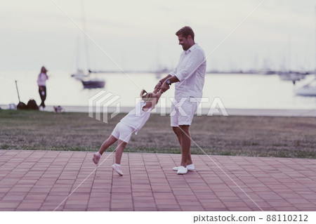 An elderly man in casual clothes with his daughter spends time together in the park on vacation. Family time. Selective focus 88110212