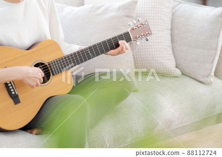 Female parts cut playing the guitar 88112724