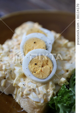 Open sandwich with lots of egg on top 88114170