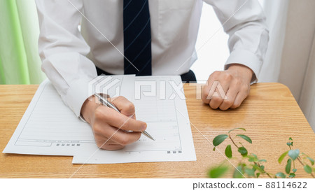 A man in a suit writing a resume │ Job hunting / job hunting image A man in a suit writing a resume │ Job hunting / job hunting image 88114622