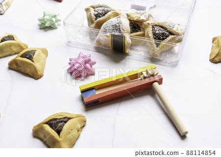 Purim celebration concept, Jewish carnival holiday, over white background. Top view, Flat lay.  88114854
