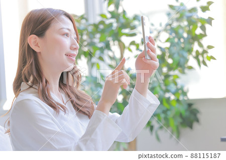 Woman taking a selfie with a smartphone 1 Woman taking a selfie with a smartphone 1 88115187