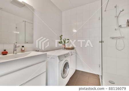 Bathroom with shower, sink and washing machine in a cozy house 88116079