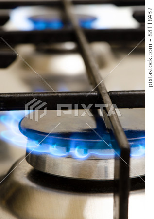 A burning gas stove. The use of natural gas at home and in the kitchen. A burning gas stove. The use of natural gas at home and in the kitchen. 88118432