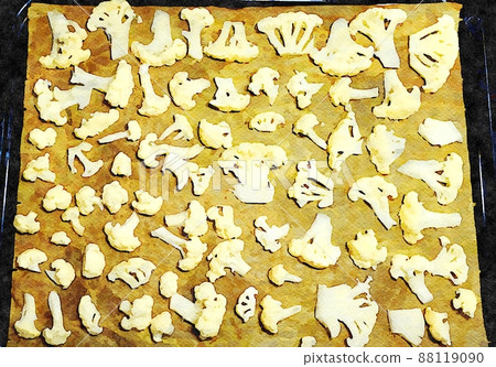A baking pan filled with cauliflower flowers to roast and dress with salad. A baking pan filled with cauliflower flowers to roast and dress with salad. 88119090