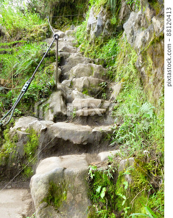 Narrow and steep stone stairs and slopes while climbing Mount Huayna Picchu, Peru 88120413