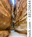 A very narrow walkway seek in a rock crevice at the Petra archaeological site in Jordan 88120644