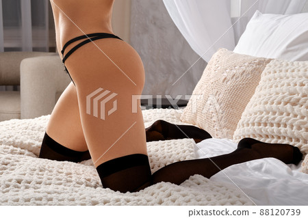 Cropped image of female legs in stockings Cropped image of female legs in stockings 88120739