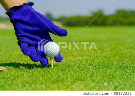 Hand Golfer hold Golf ball with tee ready to be shot at golf court Hand Golfer hold Golf ball with tee ready to be shot at golf court 88122221