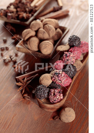 Chocolate truffles on a wooden table. 88122523