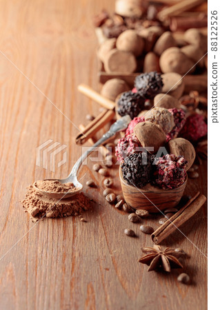 Chocolate truffles and spoon with cocoa powder. Chocolate truffles and spoon with cocoa powder. 88122526