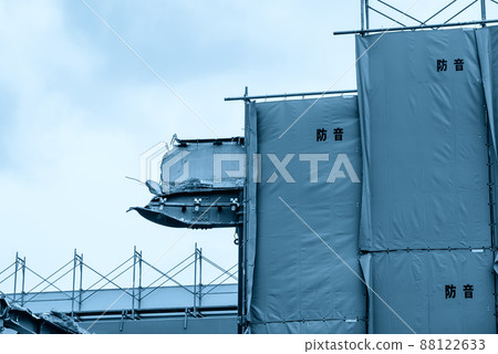 Temporary scaffolding and soundproofing sheets at a demolition site Temporary scaffolding and soundproofing sheets at a demolition site 88122633