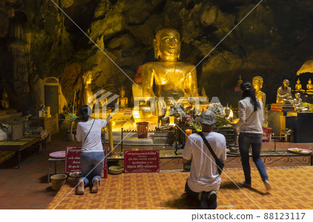 Phetchaburi, Thailand - November 11, 2018 : The golden Buddha inside Khao Luang Cave in Phetchaburi,Thailand on November 11, 2018. 88123117