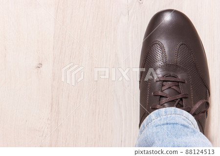 Brown leather shoes for men on white board, male footwear concept, copy space for text 88124513