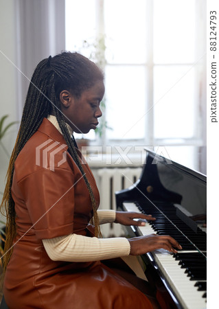 Woman playing on grand piano Woman playing on grand piano 88124793