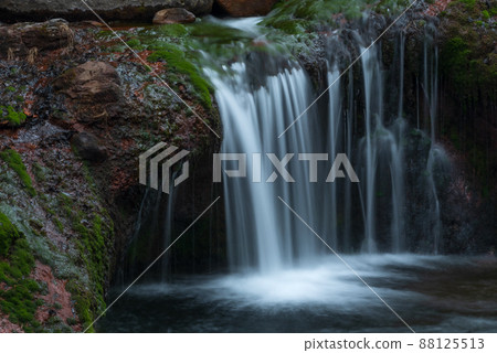 Clear stream flowing over red rocks Clear stream flowing over red rocks 88125513