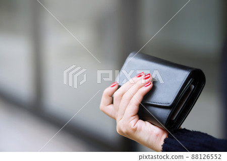 woman person holding a wallet in the hand. Cost control expenses shopping in concept. Leave space to write descriptive text. woman person holding a wallet in the hand. Cost control expenses shopping in concept. Leave space to write descriptive text. 88126552