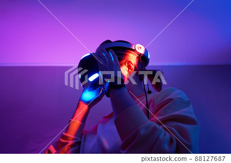 Woman interacts with virtual reality using a vr headset. Woman interacts with virtual reality using a vr headset. 88127687