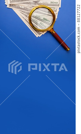 Money with a magnifying glass. Tax, return search or financial r 88127722