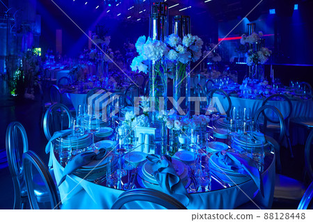 Table setup in blue light. Ready to event. Shallow dof. 88128448