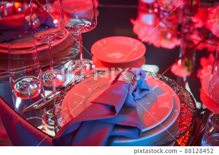 Table setup in red light. Ready to event. Shallow dof Table setup in red light. Ready to event. Shallow dof 88128452