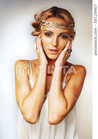 young blond woman dressed like ancient greek godess, gold jewelry closeup isolated, beautiful girl hands manicured red nails 88129467