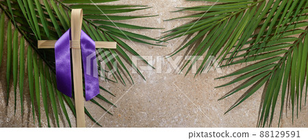 Palm cross and palm leaves. Palm sunday and easter day concept. Palm cross and palm leaves. Palm sunday and easter day concept. 88129591