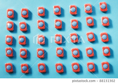 capsules for kitchen dishwashers on a blue background. flat lay. 88131302