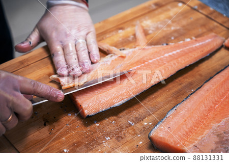Chef preparing a salmon fish 88131331